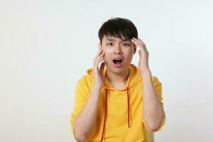 Young good looking Asian chinese malay man pose face body expression mode emotion on white background moth open shout surprised hand photo