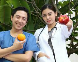 South East Asian young Malay Chinese man woman medical doctor stethoscope apron group stand pose confident photo