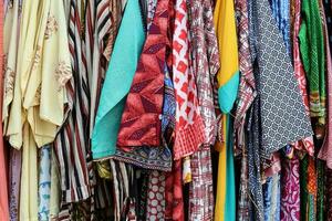 Colorful variety shirts cloths dress hanging on hangers display outdoor photo