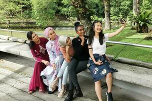 group of five woman Malay Chinese Indian Asian Malaysian outdoor green park lake nature selfie smartphone camera self portrait photo