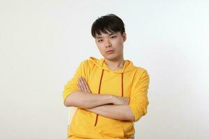 Young good looking Asian chinese malay man pose face body expression mode emotion on white background cross arm on chest look sad photo