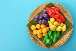 Colourful Luk chup look choop tadeonal Thai desert sweets candy creatve variety bamboo plate banana leaf photo