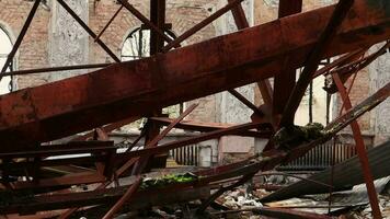 The bombed building of the house of culture in the city. War of Russia against Ukraine. Destroyed floor beams inside the building, which was hit by an artillery shell, rocket or air bomb. video