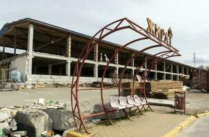 Devastating landscapes with a burnt and broken facade of a shopping center. Translation Giraffe. The terrible consequences of the war in Ukraine. Ukraine, Irpin - April 29, 2023. photo