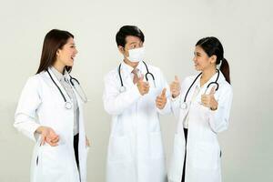 Young Asian male female doctor wearing apron stethoscope thumbs up photo