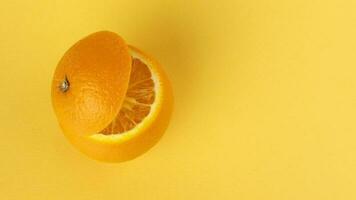 Healthy Orange Cut floating top slice juice drink idea concept on yellow background photo