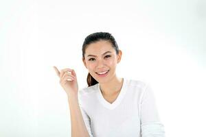 beautiful young south east Asian Chinese woman pointing finger up look at camera on white background photo