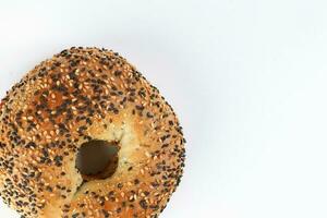 Toasted sliced black seed sesame bagel bread on white background photo