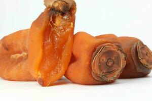 dried permission fruit on white background photo