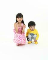 south East Asian brother sister child playing posing on white background photo