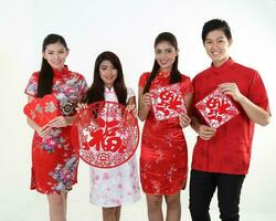 South East Asian young Malay Chinese Indian man woman wearing traditional chinse cheongsam dress on white background shop exchange gift orange greetings share racial unity harmony hand fan photo