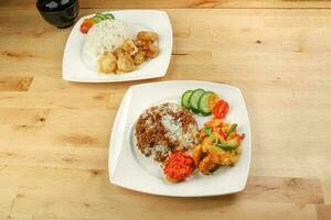 Turmeric fried chicken ayam goreng kunyit black sauce rice and butter chicken rice photo