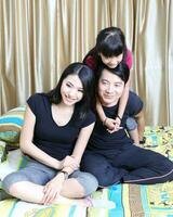 South East Asian young father mother daughter  parent girl child activity indoor photo