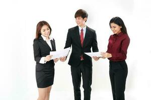 Young attractive one man two woman business office white background stand looking reading looking documents study point photo