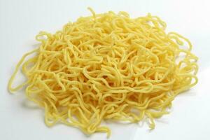 Fresh yellow egg noodle on whit background photo