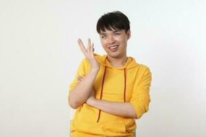 Young good looking Asian chinese malay man pose face body expression mode emotion on white background cross arm on chest look happy hand in air photo