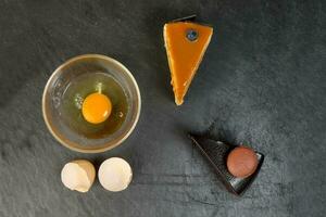 Raw Egg cake flower ingredient on black slate stone photo