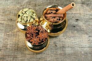 mix spice in golden metal pot on rustic wo photo