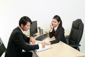 Young Asian man woman wearing business office suit chair table computer white background photo