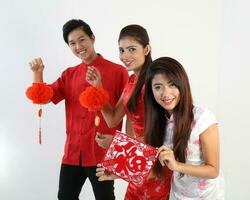 South East Asian young Malay Chinese Indian man woman wearing traditional chinse cheongsam dress on white background shop exchange gift orange greetings share racial unity harmony hand fan photo