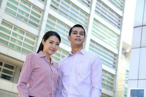 Young south east Asian middle eastern man woman business colleague outdoor stand pose photo