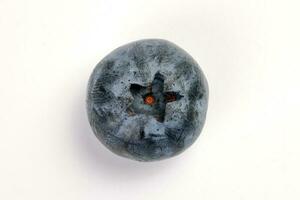 Fresh ripe deep purple Blueberry on white background macro closeup top view photo