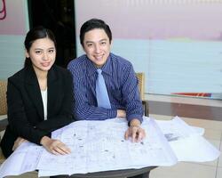 South East Asian young Malay Chinese man woman wearing safely helmet construction site work photo