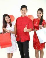 South East Asian young Malay Chinese Indian man woman wearing traditional chinse cheongsam dress on white background shop exchange gift orange greetings share racial unity harmony hand fan photo