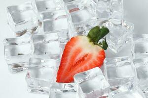 Strawberry read ice cube on white background photo