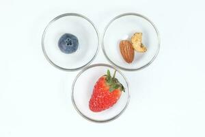 Blueberry Strawberry Herb Spice Almond Cashew Nut in glass bowl on white background photo