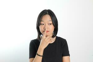 Young attractive south east asian woman pose face expression emotion on white background think worry finger on nose photo