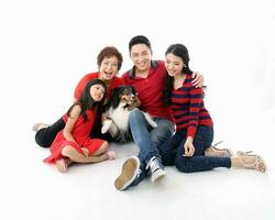 Southeast Asian multigeneration family parents daughter grandmother father mother child pose happy sit stand photo