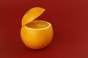 Healthy Orange Cut floating top slice juice drink idea concept on red background photo