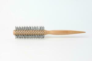 Round hair brush comb on white background photo