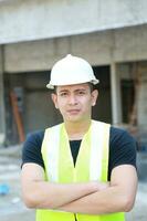 South East Asian young Malay Chinese man woman wearing safely helmet construction site work photo