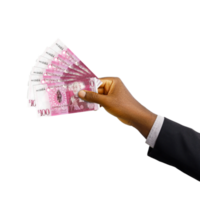 Black hand with suit holding 3D rendered Tongan Paanga notes isolated on  transparent background png