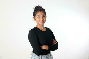 Young attractive Asian Indian woman pose face body expression mode emotion on white background stand crossed arm confident look at camera photo