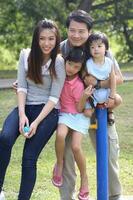 South East Asian young father mother daughter son parent boy girl child activity outdoors park photo