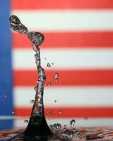 Water droplet drop splash collision dripping pillar Malaysia Flag reflection refraction independence country patriot photo