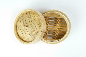 Wooden bamboo dim sum steamer on white background photo