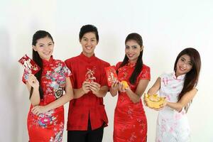 South East Asian young Malay Chinese Indian man woman wearing traditional chinse cheongsam dress on white background shop exchange gift orange greetings share racial unity harmony hand fan photo