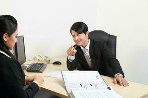 Young Asian man woman wearing business office suit chair table computer white background photo