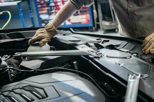 Car Mechanic Checking On Engine Coolant Level photo