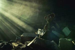 Aged Teddy Bear Inside Abandoned House Ruins Brighten Up by Sun Rays photo