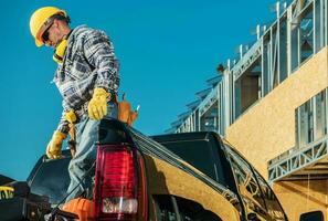 Construction Worker Taking Tools Out of Trunk photo