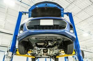 Vehicle on an Automotive Lift During Maintenance photo