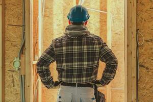 Contractor Worker in Front of Newly Built House Interior photo