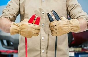 Car Mechanic with Jumper Cables in His Hands photo