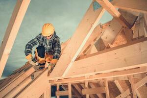 Wooden House Roof Beams Assembly by Construction Worker photo