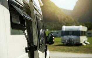 Class B Camper Van RV Motorhome and a Travel Trailer in a Background photo